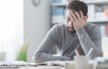 tired man sitting at the desk